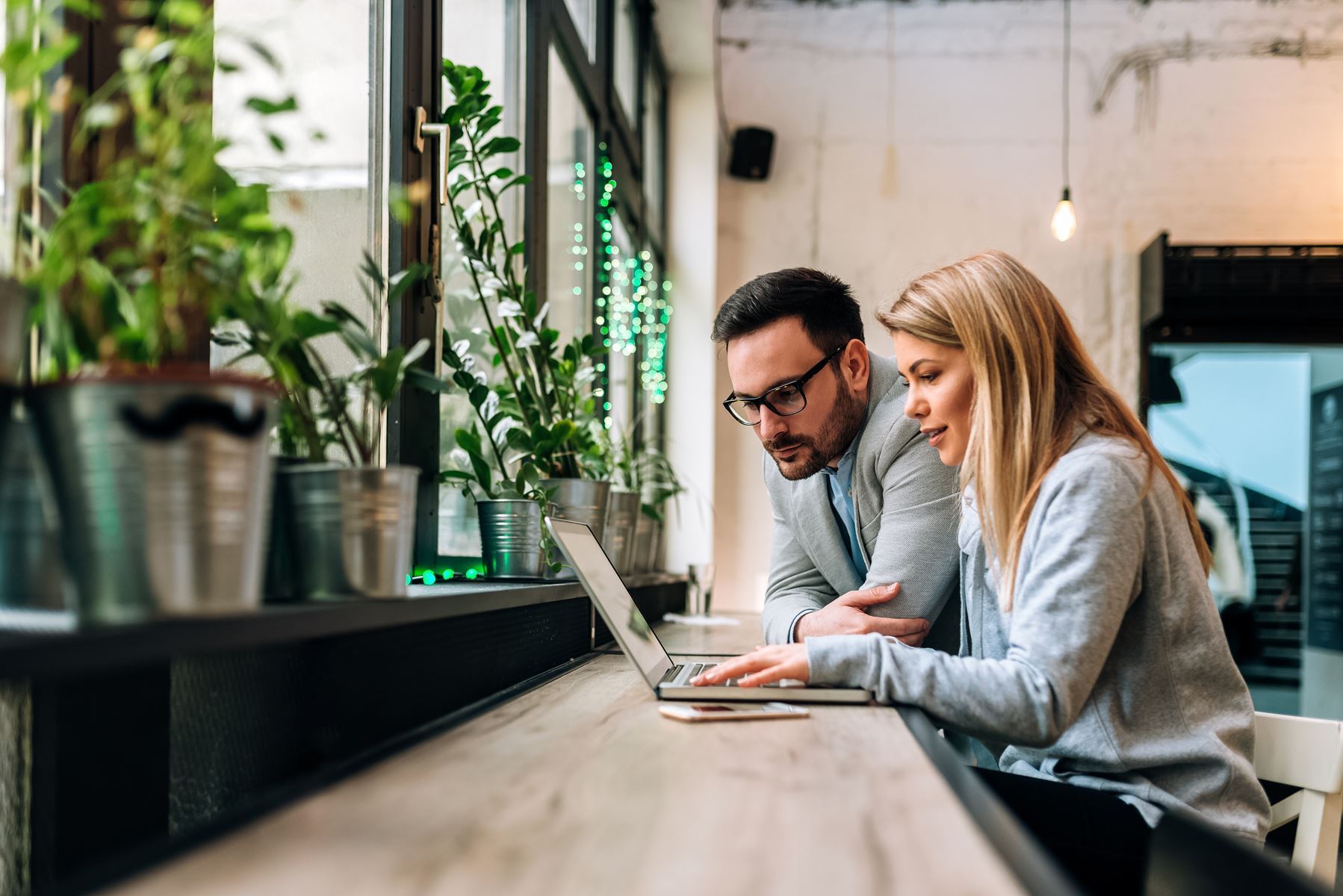 Man and woman looking at a laptop screen